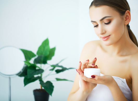A beautiful woman using a skin care product